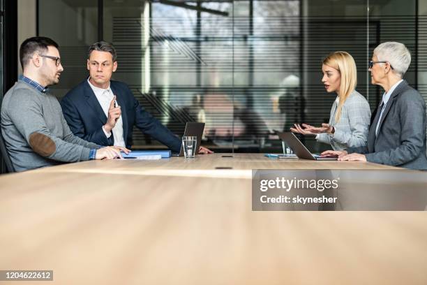 young couple and their lawyers taking about separation in the office. - legal counsel stock pictures, royalty-free photos & images