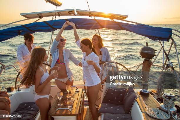 multi generation female crew on sailboat having a party - sailing greece stock pictures, royalty-free photos & images