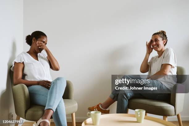 smiling women talking together - two women talking stock pictures, royalty-free photos & images