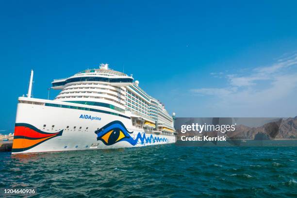 cruise ship aidaprima in the port of oman with the typical lips as logo - aida prima stock pictures, royalty-free photos & images