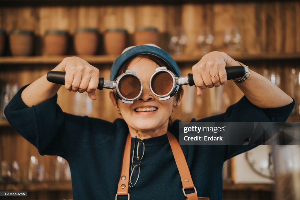 Happy face with active senior women barista and her working tool