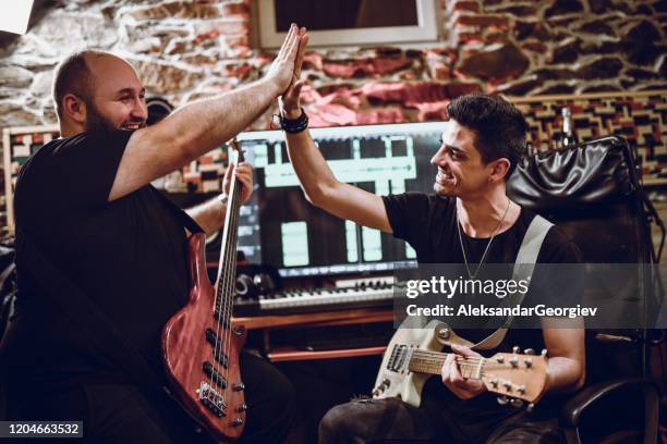 guitarist and bassist happy after recording tough performance part together - southwest music stock pictures, royalty-free photos & images