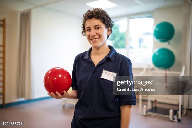 physiotherapist with a massage ball at rehab center - physical therapist stock pictures, royalty-free photos & images