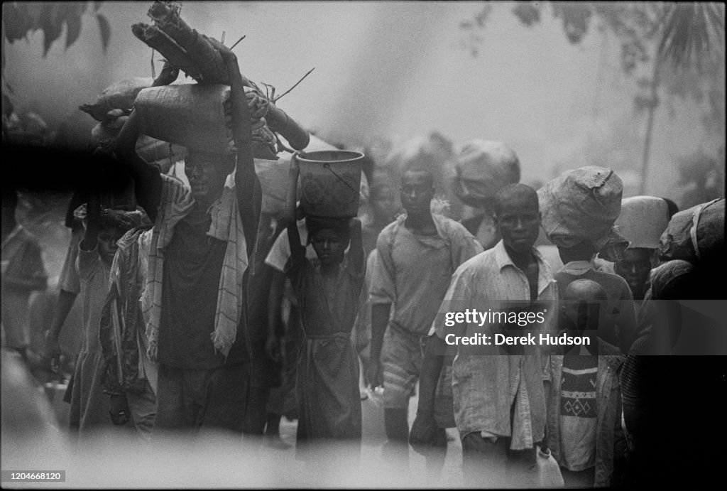 Umunsima Rwanda View of Rwandan Hutu refugees, many with their possessions balanced ...