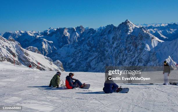 Snowboarders lay down on the Zugspitze mountain for alpine snowboarding on January 21, 2020 in Garmisch-Partenkirchen, Bavaria, Germany. Zugspitze is...