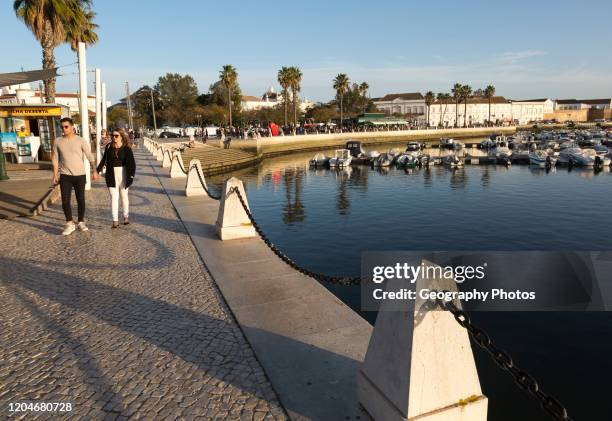 Activity around the marina area with people walking along the waterfront, Faro, Algarve, Portugal, Europe.
