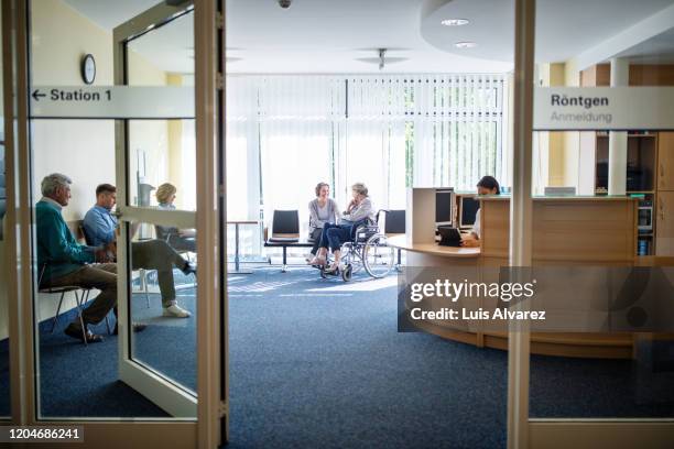 patients in waiting room at hospital - arztpraxis stock-fotos und bilder