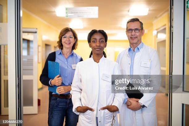 multi-ethnic healthcare workers are in hospital - three female doctors stock pictures, royalty-free photos & images