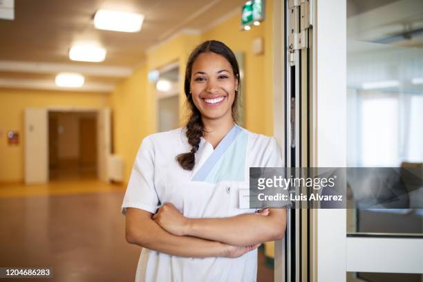 portrait of confident female nurse at doorway - female nurse bildbanksfoton och bilder