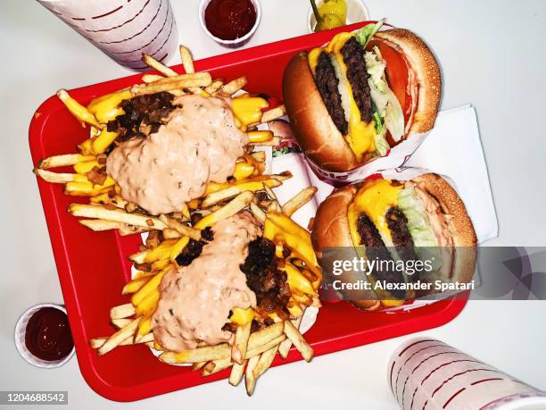 two burgers with french fries and soda high angle view - fast food fotografías e imágenes de stock