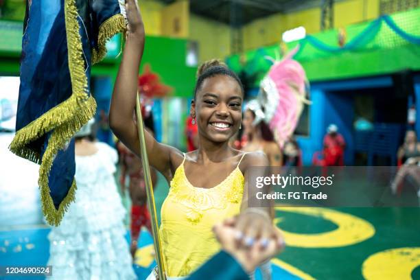 young woman (porta bandeira) celebrating and dancing brazilian carnival at school carnival - samba dancer imagens e fotografias de stock