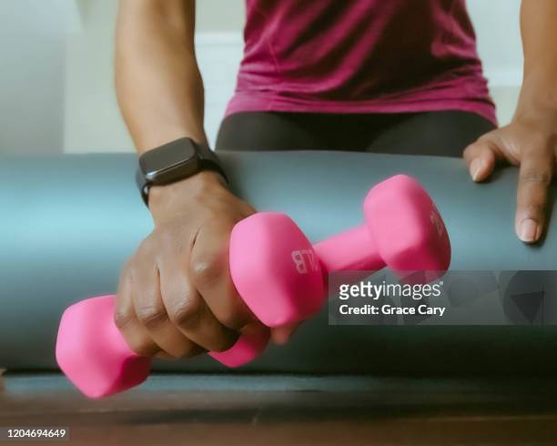 woman grabs lightweight dumbbells - womens hand weights stock pictures, royalty-free photos & images
