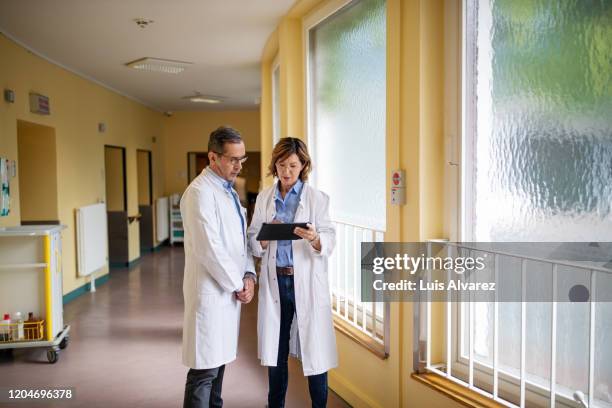 Two Physicians Two Doctors Talking Standing Photos and Premium High Res Pictures ...