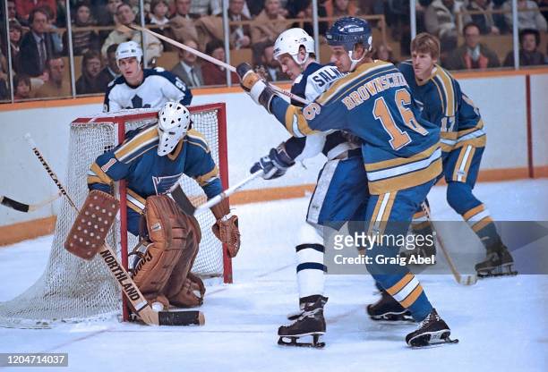 Mike Liut, Jack Brownschidle and Ed Kea of the St. Louis Blues skate against Wilf Paiement and Borje Salming of the Toronto Maple Leafs during NHL...