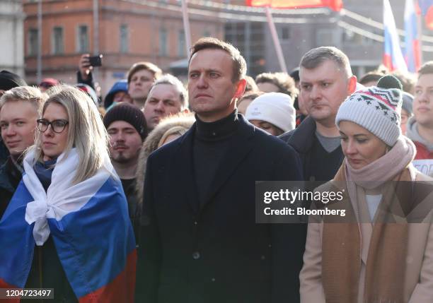 Alexey Navalny, Russian opposition leader, center, and his wife Yulia, right, walk with demonstrators during a rally in Moscow, Russia, on Saturday,...