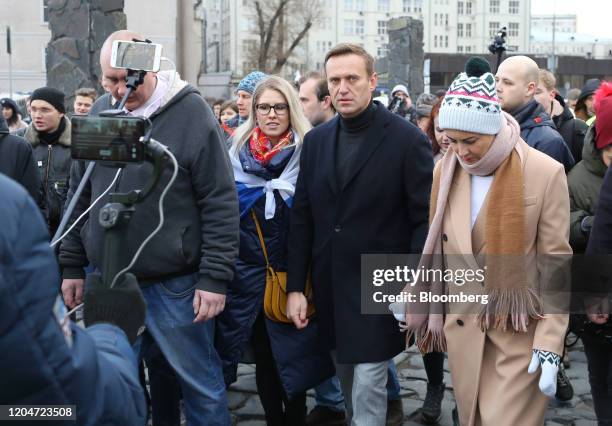 Alexey Navalny, Russian opposition leader, second right, and his wife Yulia, right, walk with demonstrators during a rally in Moscow, Russia, on...