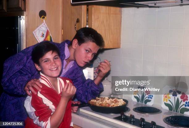 American actors Joaquin and River Phoenix cooking at their home in Los Angeles, California, US, circa 1985.