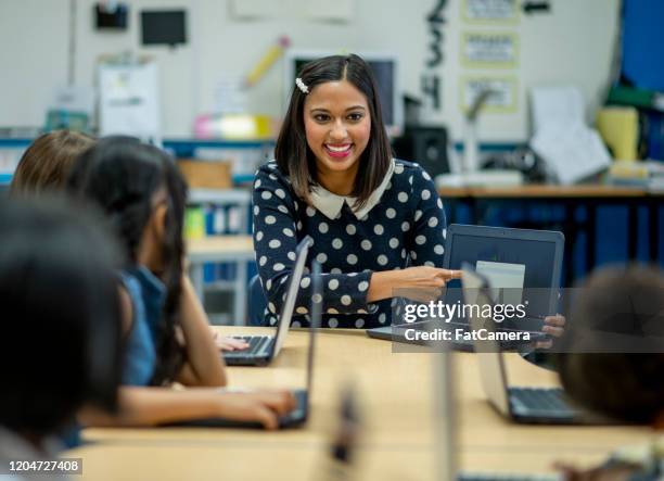 teacher leading students in computer class stock photo - students working on pc school stock pictures, royalty-free photos & images