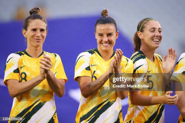 Elise Kellond-Knight , Chloe Logarzo and Karly Roestbakken of the Matildas share a laugh after the national anthem before the Women's Olympic...