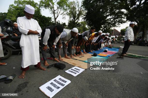 Group of Muslims from various Islamic community organizations pray during the solidarity action for Indian Muslims in front of the Indian Consulate...