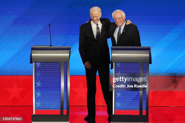 Democratic presidential candidates former Vice President Joe Biden and Sen. Bernie Sanders share a moment during the Democratic presidential primary...