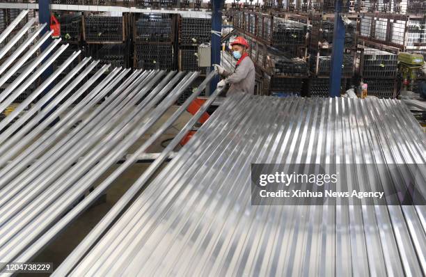 March 2, 2020 -- A worker works at the spraying workshop of an aluminum company in a characteristic industrial park in Xundian Hui and Yi Autonomous...