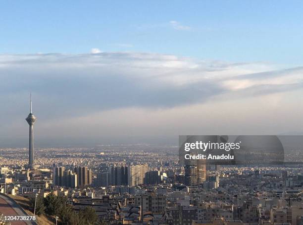 Cloudy and clear sky cover Iran's capital Tehran on March 02 as air pollution levels drops due to coronavirus outbreak. Many factories stopped...