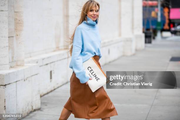 Ekaterina Mamaeva seen wearing brown skirt Joseph, Celine clutch, light blue turtleneck knit Bazilika, bracelet Louis Vuitton, Chanel earrings during...