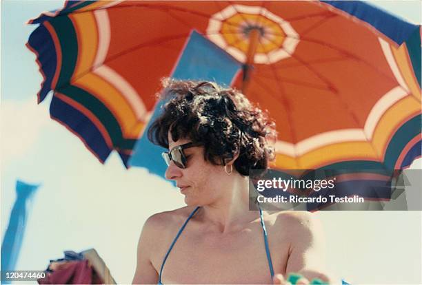 woman - beach umbrella stock pictures, royalty-free photos & images