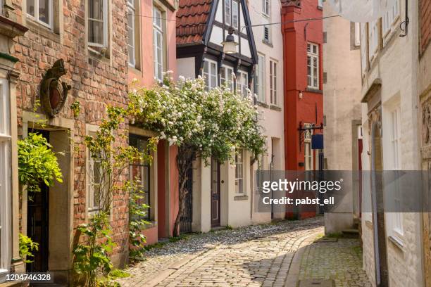 alley with old traditional houses at bremen altstadt germany - bremen stock pictures, royalty-free photos & images