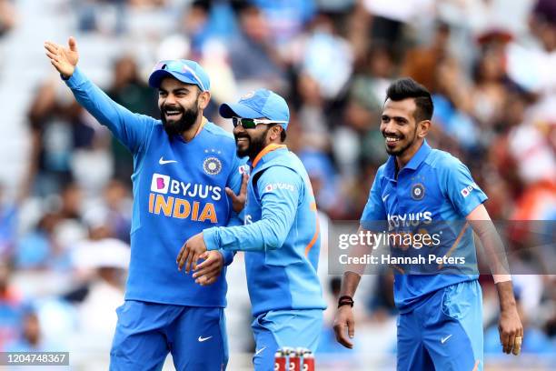 Virat Kohli, Kedar Jadhav and Yuzvendra Chahal of India celebrate the wicket of Tim Southee of the Black Caps during game two of the One Day...