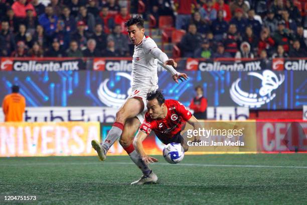 Adrian Mora of Toluca struggles for the ball against Erick Torres of Tijuana during the 5th round match between Tijuana and Toluca as part of the...