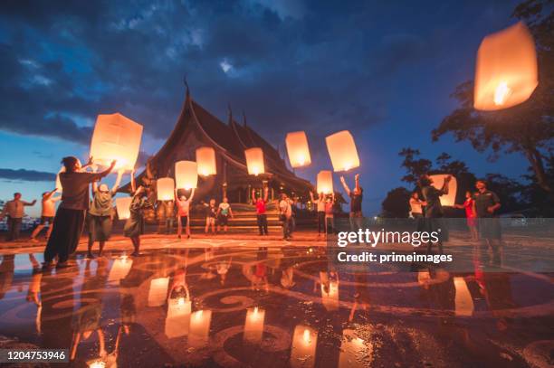 grupo de jovens lançando lanternas no templo sirindhorn wararam phu prao - yi peng - fotografias e filmes do acervo