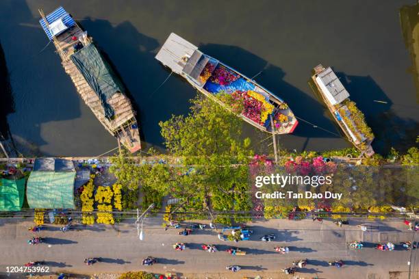 vietnam, ho chi minh city - the binh dong wharf floating market in tau hu canal in hcm city district 8, high quality aerial view - tet vietnam stock pictures, royalty-free photos & images