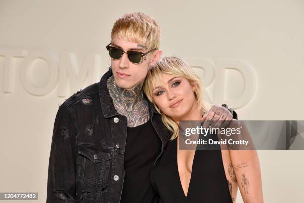 Trace Cyrus and Miley Cyrus attend the Tom Ford AW/20 Fashion Show at Milk Studios on February 07, 2020 in Los Angeles, California.