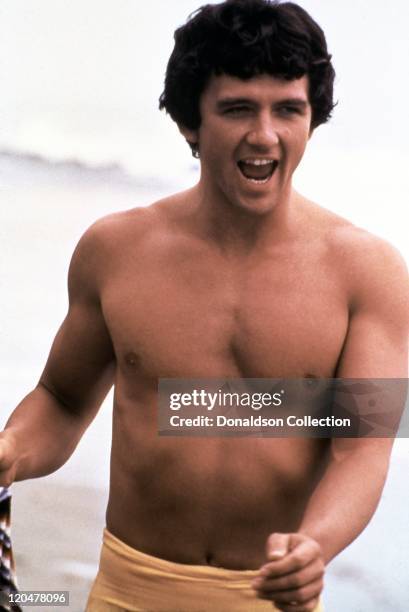 Actor Patrick Duffy runs on the beach in 1986 in Los Angeles, California.