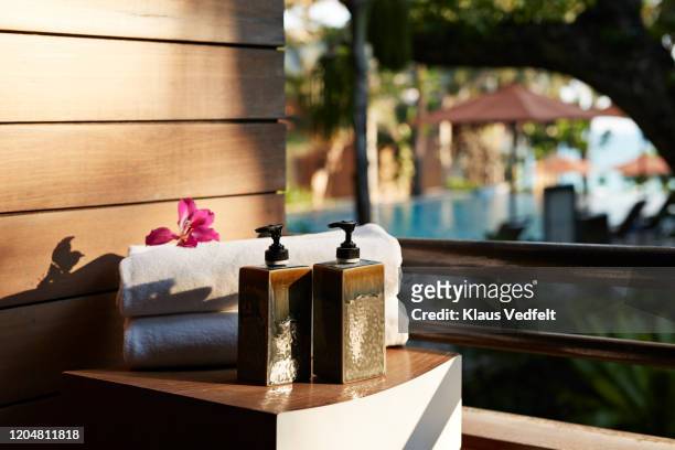 refill bottles with towels on table at tourist resort - amenities stock pictures, royalty-free photos & images
