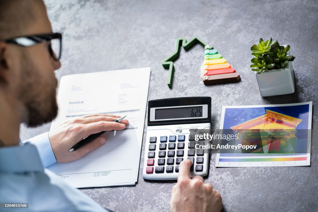 Man Calculating House Energy Efficiency Rate