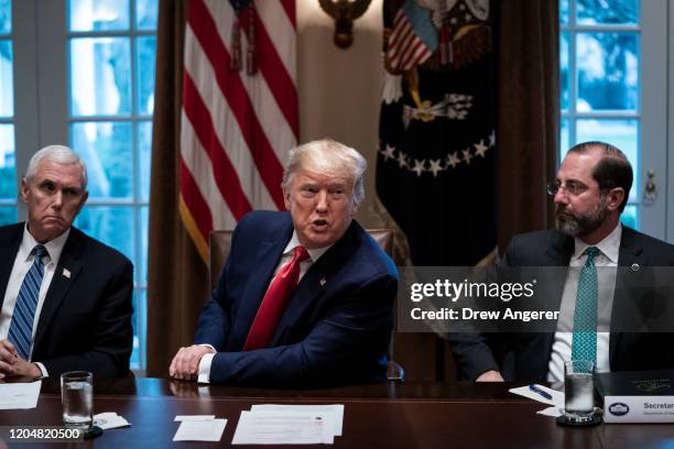 Flanked by U.S. Vice President Mike Pence and Secretary of Health and Human Services Alex Azar, U.S. President Donald Trump speaks during a meeting...