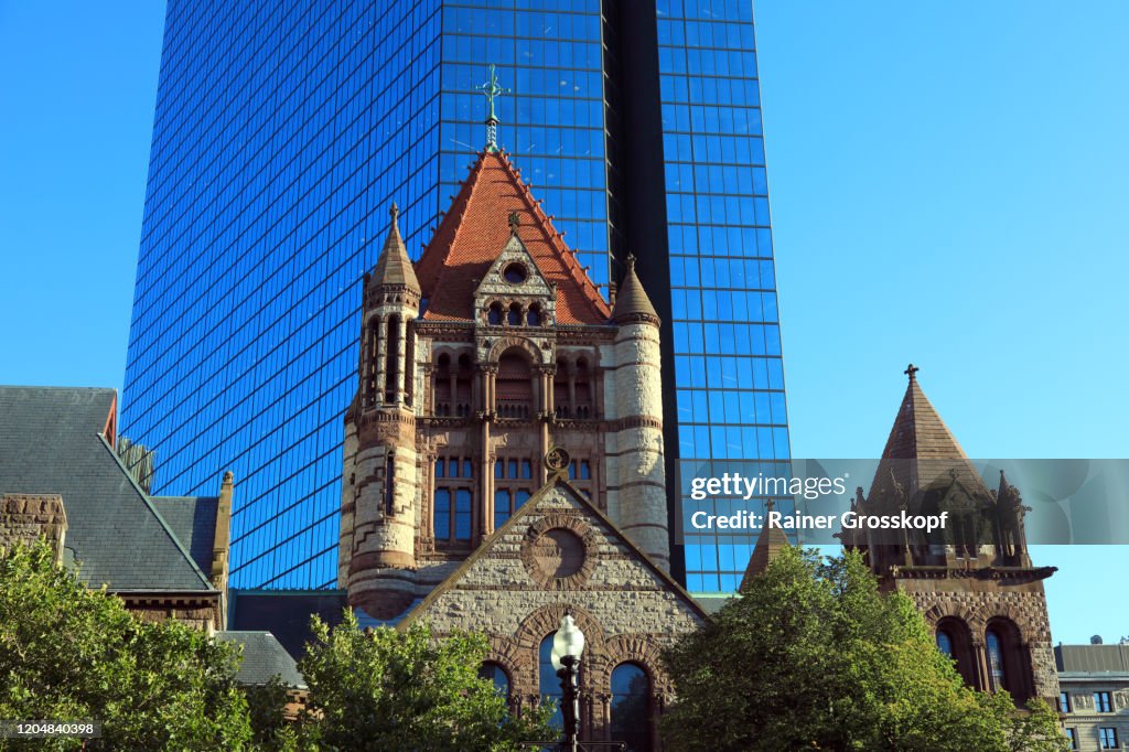 Trinity Church in front of the shiny metallic facade of 200 Clarendon, the former John Hancock Tower