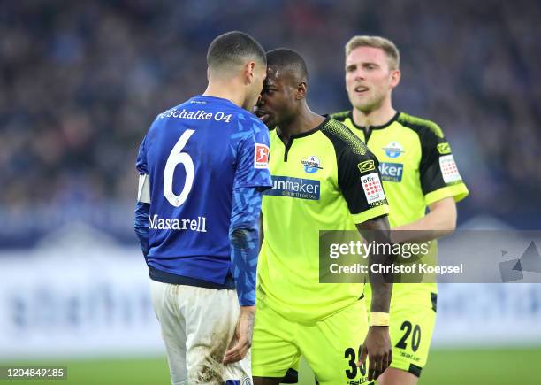 Omar Mascarell of FC Schalke 04 confronts Streli Mamba of SC Paderborn 07 during the Bundesliga match between FC Schalke 04 and SC Paderborn 07 at...