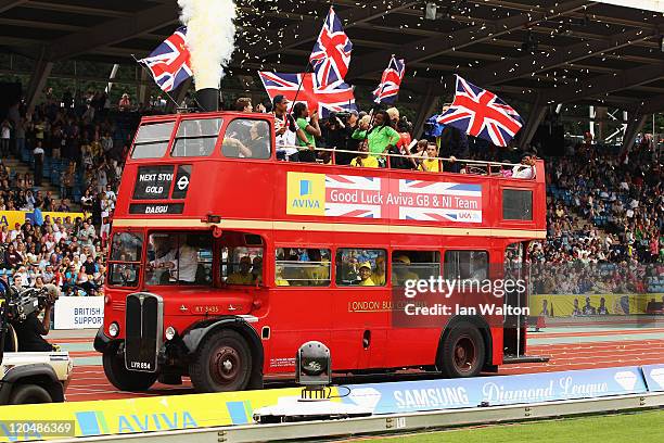 Great Britain and Northern Ireland athletes wave to the crowd from an open top Routemaster bus after competing in the Aviva London Grand Prix at...