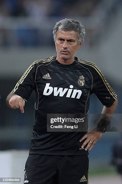 Coach Jose Mourinho of Real Madrid looks on during the pre-season friendly match between Tianjin Teda and Real Madrid at Water Drop Stadium on August...