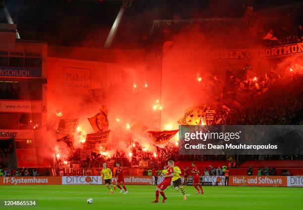 General view inside the stadium as fans light flares during the Bundesliga match between Bayer 04 Leverkusen and Borussia Dortmund at BayArena on...
