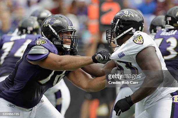 Jah Reid of the Baltimore Ravens blocks Cory Redding during training camp at M&T Bank Stadium on August 6, 2011 in Baltimore, Maryland.