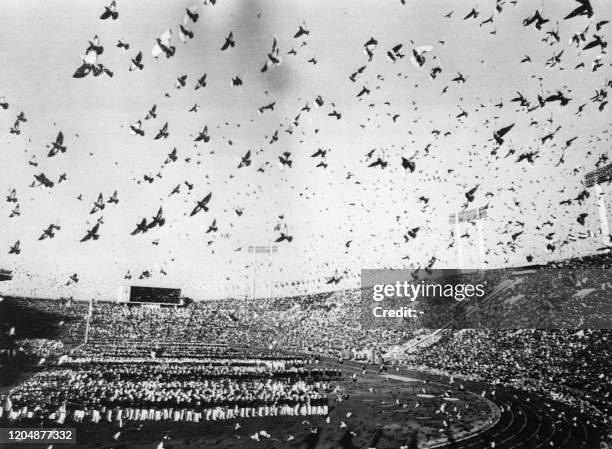 Picture taken on October 10, 1964 at Tokyo showing a general view of pigeons' flight while the national delegations taking part in the Olympic Games...