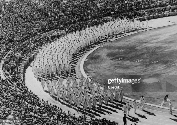 Picture taken on October 10, 1964 at Tokyo showing the two German national delegations parading in the stadium of the Olympic Games during the...