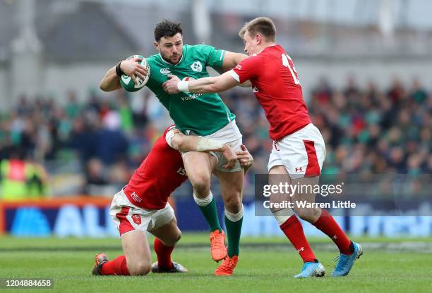 Robbie Henshaw of Ireland is tackled by Hadleigh Parkes of Wales and Nick Tompkins of Wales during the 2020 Guinness Six Nations match between...