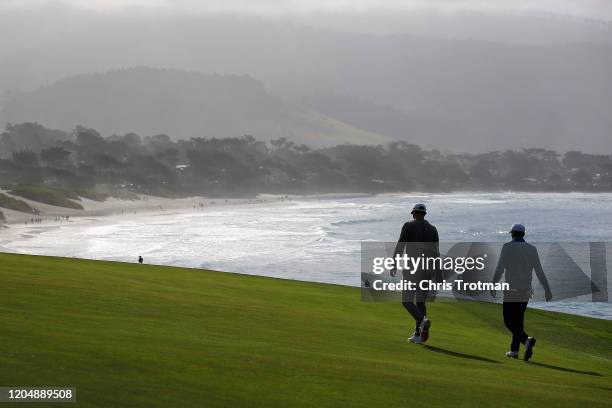 Dustin Johnson of the United States and Jordan Spieth of the United States walk up the ninth fairway during the third round of the AT&T Pebble Beach...