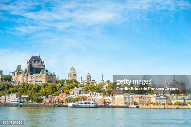 panoramic view of québec city with the famous and iconic hotel chateau frontenac and the saint lawrence river against a clear sky - ville de québec photos et images de collection